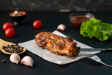 hot roasted barbecued beef steak with red sauce, onion and spice, lettuce leafs