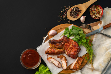 Grilled ribeye beef steak, herb leafs and  spices around, top view with copy space for your texts