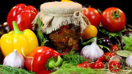 Home preservation. Glass jar with peppers and tomatoes