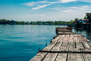 Wooden pier on the bay with blue water