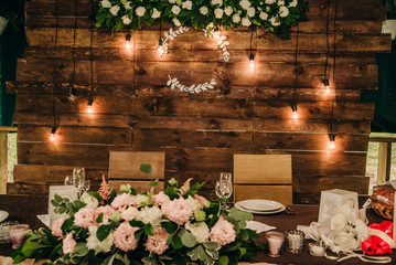 brown wooden wall at the table in the banquet hall for a wedding celebration with a monogram for...
