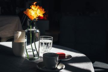 Cup of coffee with a bouquet of yellow narcissus