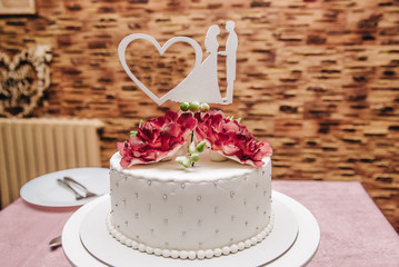 beautiful cake for a wedding with a heart-shaped decoration on top