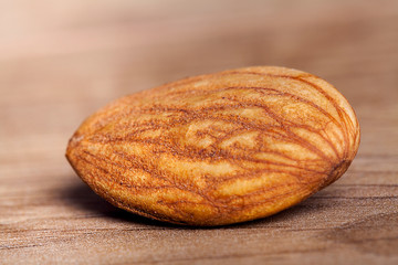 Almond on wooden table. Healthy food and snack.
