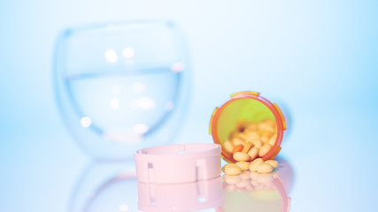 can of pills and a glass of water