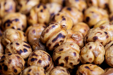 Roasted and dry chickpeas on wooden table. 