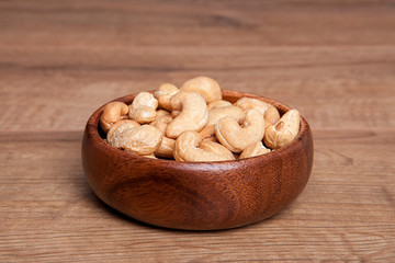 Cashew in a bowls on wooden table.Healthy food and snack.