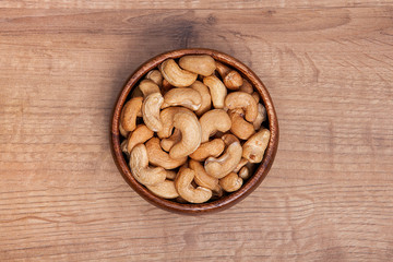 Cashew in a bowls on wooden table.Healthy food and snack.