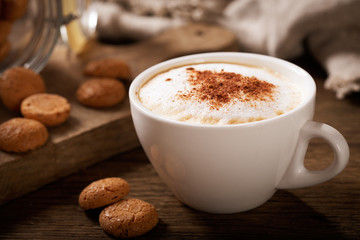 cup of cappuccino coffee with cookies