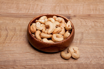 Cashew in a bowls on wooden table.Healthy food and snack.