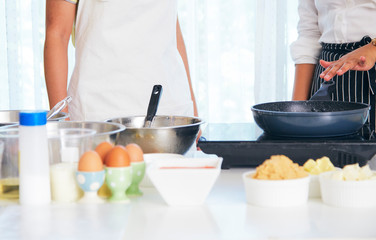 Young woman cook sweet cake in the kitchen