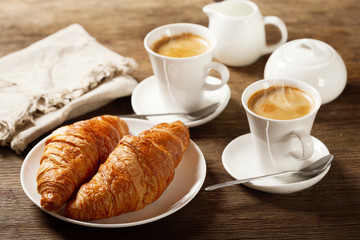 breakfast with cups of coffee and croissants
