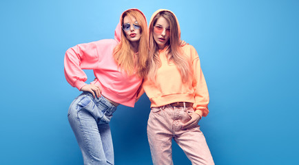 Two Young carefree hipster Girl Having Fun. Beautiful fashionable Woman in trendy urban Outfit....