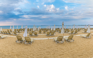 Chairs and umbrellas on a beautiful beach at Sunny Beach on the Black Sea coast of Bulgaria. Panoramic view