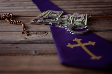 Banknotes and catholic church symbols.