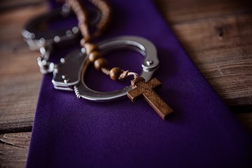 Catholic church symbols and handcuffs.