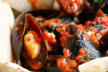 Fototapeta na wymiar pizza with mussels on table restaurant traditional pizza with basil leaf close up