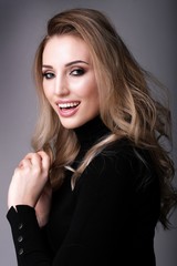Fototapeta premium Beautiful woman with gentle smile on grey background.