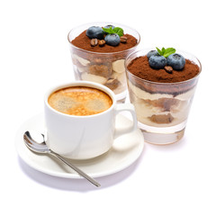 Classic tiramisu dessert with blueberries in a glass and cup of coffee isolated on a white background with clipping path