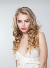 Naklejka premium Pretty woman with healthy blonde curly hair. Beautiful model with makeup