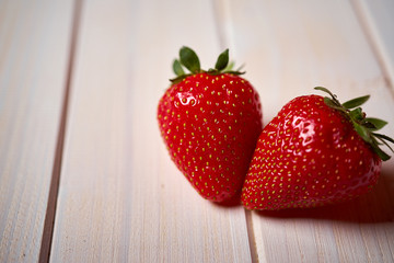 Close up of fresh juicy red strawberries on  white  table