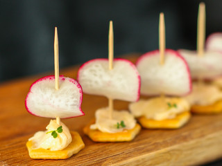 radish, canape appetizer, salad snack with cream cheese, vegetables and herbs (snack). food background. top view