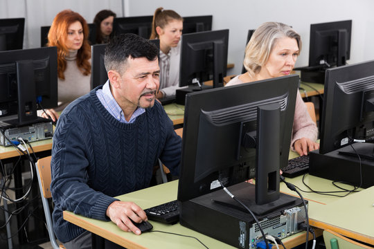 Focused mature man during computer classes