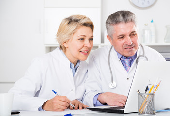 Doctor and nurse reading information