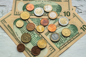 Euro coins of different denominations on the background of dollar bills.Close-up of several euro coins. Concept of trading on the stock exchange. Euro exchange rate