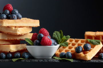 Waffles with  blueberries, raspberries  and fresh mint.