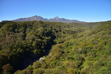 Fototapeta premium Mountains with red leaves and blue sky