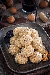 Snack cheese balls with prunes and walnuts, selective focus