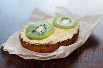 Snack, lunch, kiwi sandwich on pastry paper, side view