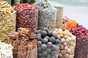 Dried spices in transparent packages standing on the counter in the street market in Dubai