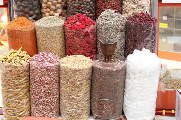 Dried spices in transparent packages standing on the counter in the street market in Dubai