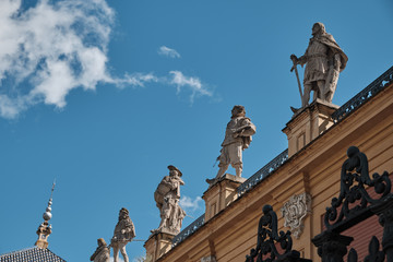 Obraz premium statue on old building in seville in a sunny day - spain - body copy - negative space - blue sky.