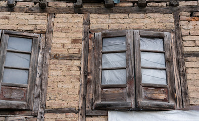 Abandoned house with old wooden window