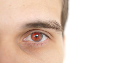 Close up of a male eye. Detail of a red eye of a man looking at camera