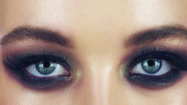 Smoky eyes. Close-up eyes of caucasian woman with smoky eyes makeup looking at camera. Fashion makeup