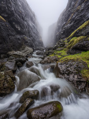 Misty gorge with floating creek, Faroe Islands - 267960750