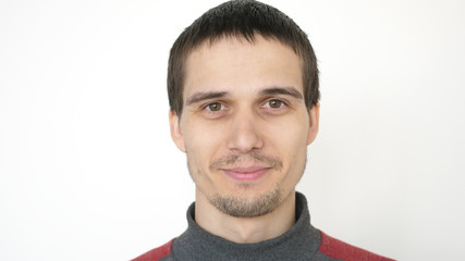 Portrait of young attractive smiles man on a white background