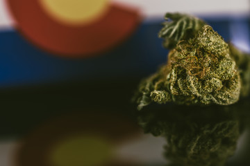 Medical Cannabis in Colorado - frosty strain with lots of resin in medical cannabis and flag of State Colorado.