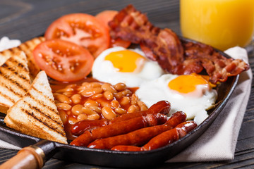 delicious English breakfast on a dark rustic background
