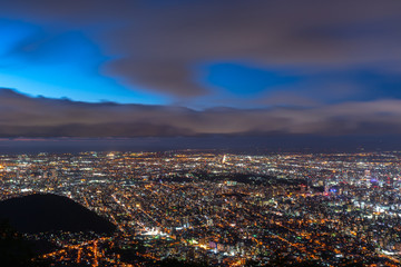 Night cityscape view of Sapporo city from Mountain Moiwa observation. The most popular tourist destinations viewpoint for tourism. Sapporo, Hokkaido, Japan.