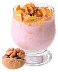 Yogurt with cornflakes and walnuts in a glass goblet