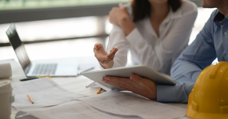 Architect designer team colleagues discussing building plan design project