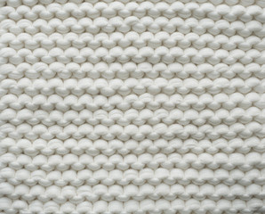 Closeup cotton white knit blanket, warm and comfortable atmosphere. Knit background