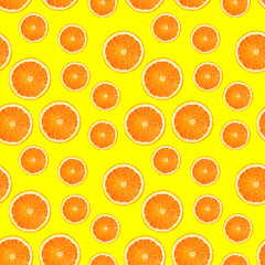 Bright summer background. Orange slices on yellow. Fruits seamless pattern. Oranges texture design for textiles, wallpaper, fabric.