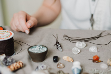 Handmade gemstone jewelry, home workshop. Woman artisan creates jewelry. Art, hobby, handcraft concept