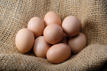 Group of fresh eggs on a bag close up. Poultry farm, chicken.